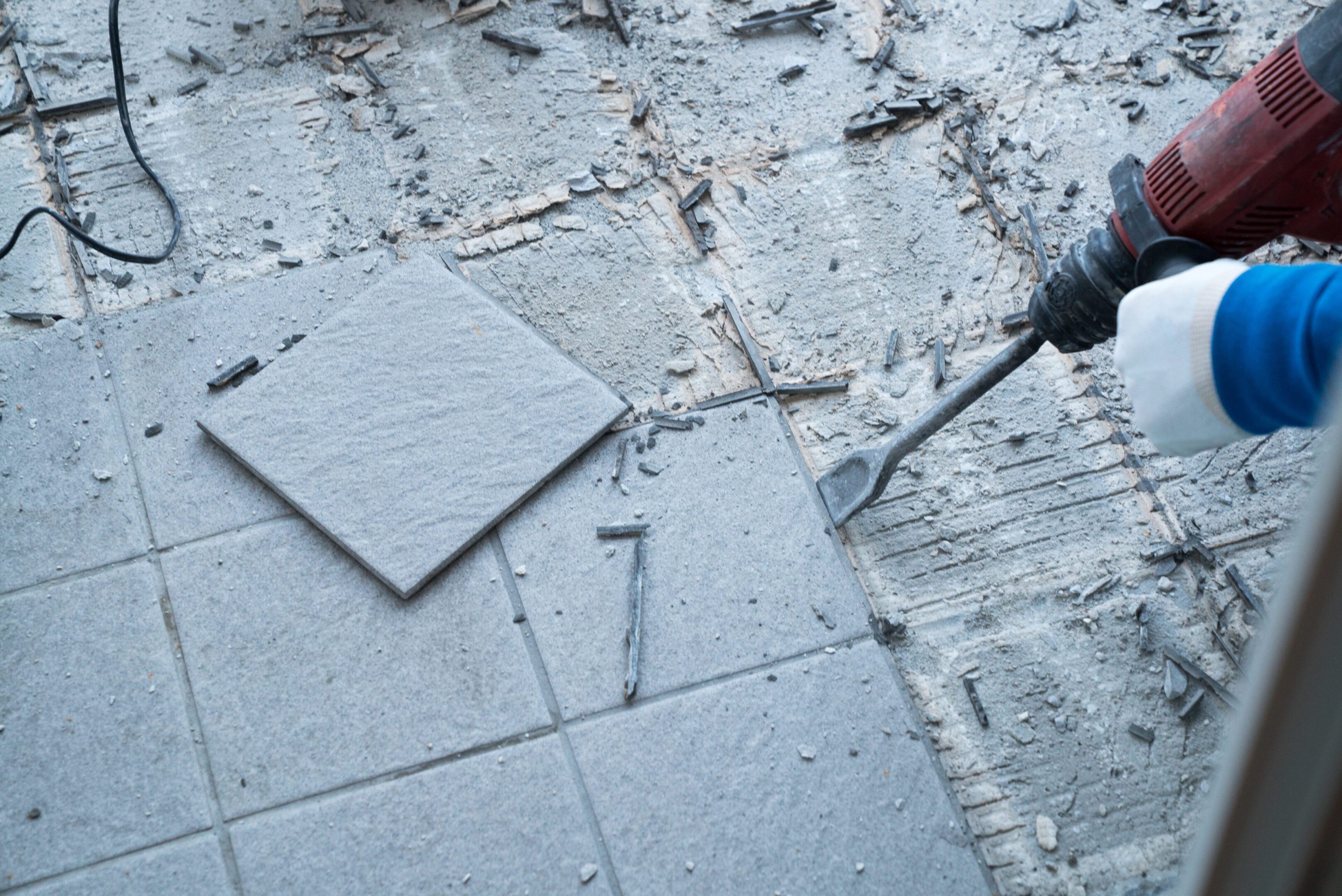 Demolition of old floor tiles in progress